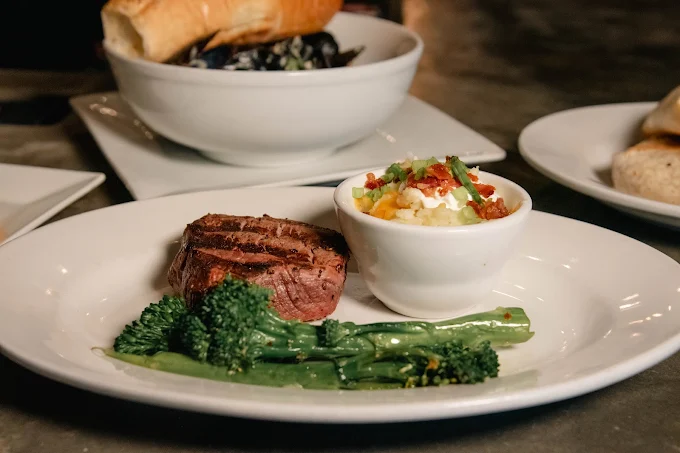 Steak and potatoes plated at The Boardroom